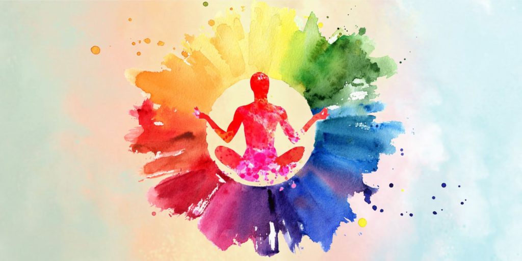 Silhouette d'un yogi entouré d'un halo de plusieurs couleurs