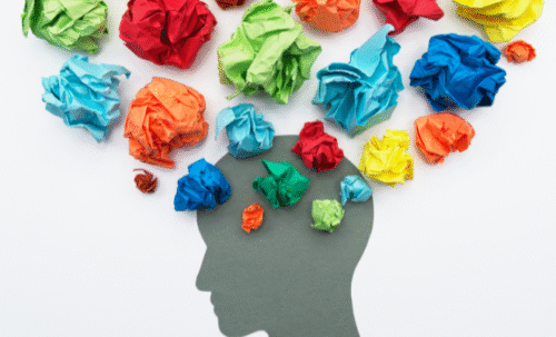 Boules de papier froissé de différentes couleur sortant d'une tête humaine en dessin